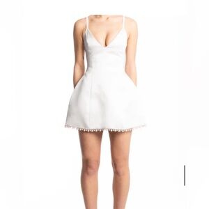 Rebecca Tembo Bello White Mini Dress. Elegant White Mini Dress with Pearl Trim